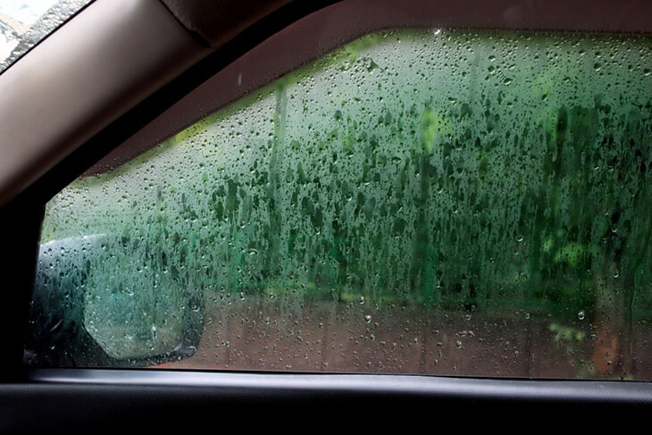 Niebla en la ventana lateral del coche